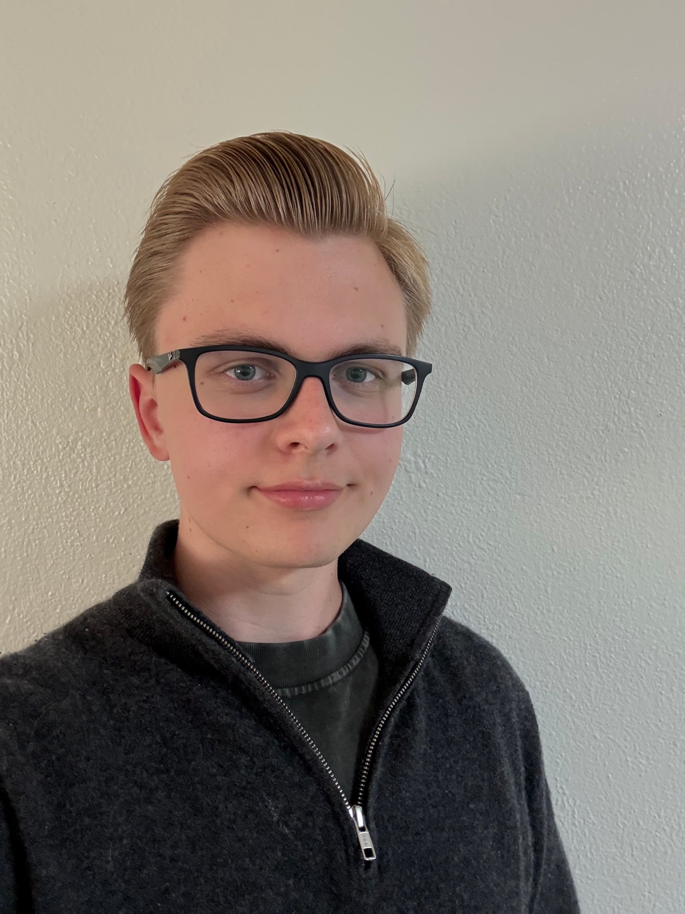 Alexander standing in front of a rocket exhibit