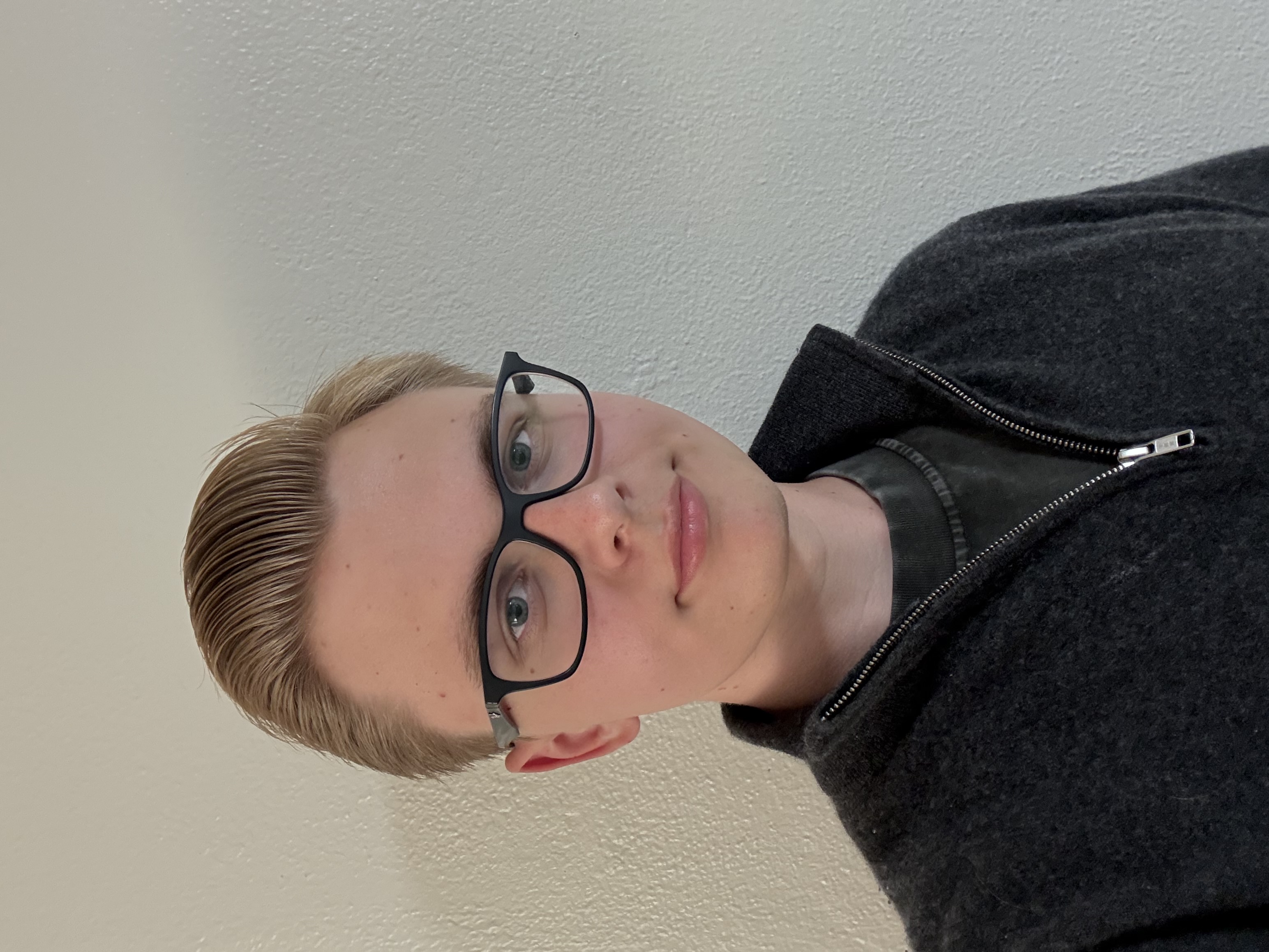 Alexander standing in front of a rocket exhibit